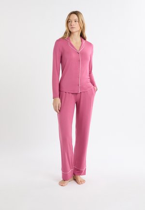 Pink pajama set with long-sleeve button-up top featuring white piping, and matching pants with an elastic waistband and cuffed hems.