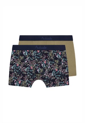 Deux paires de boxers, une verte olive et une bleue marine avec un imprimé floral multicolore, toutes deux avec une ceinture bleue marine marquée "Aubade."