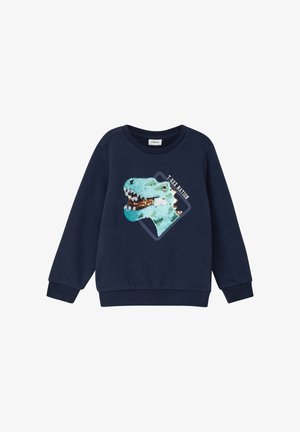 Granatowy sweter z nadrukiem T-rexa pokrytym cekinami. Posiada okrągły dekolt i ściągacze przy mankietach. Miękka tekstura, swobodny krój i radosny design.