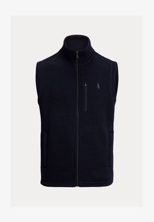 Tumes fleece'i vest, kõrge kaelusega, ees lukuga, kahe küljetaskuga ja väikese tikandiga logoga vasakul rinnal.