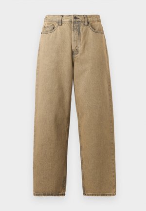 Tan denim jeans with a straight leg design, featuring a zip fly, belt loops, and contrast stitching. No notable patterns or hardware details.