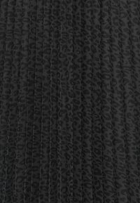 Svart, plissert stoff med et subtilt leopardmønster, teksturert overflate og en rik, mørk nyanse gjennom hele.