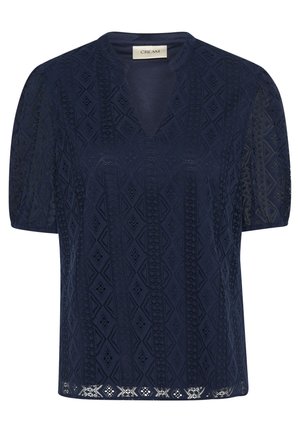 Navy blue short-sleeve top with a V-neck, textured geometric pattern, and open lace detailing at the hem and sleeves. Soft fabric.