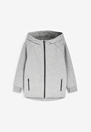 Sivi zip-up dukserica s kapom, s bočnim džepovima i raglan rukavima. Izrađena od mekog materijala s glatkom teksturom i opuštenim krojem.