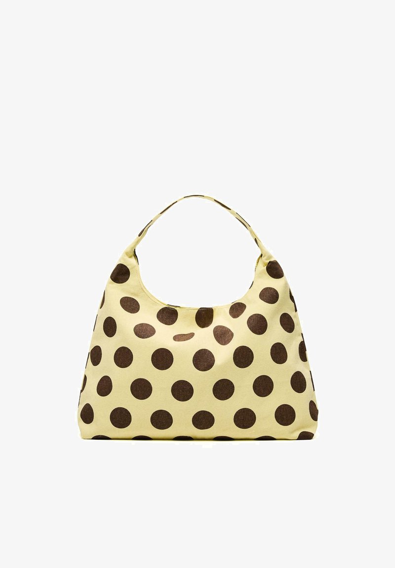 Sac à main jaune avec de grands pois marron, en tissu doux, et une anse unique.