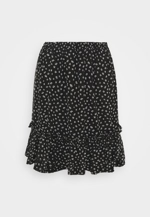 Jupe noire avec petit imprimé floral blanc, taille élastique et détail volanté à l’ourlet.