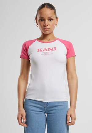 White t-shirt with pink raglan sleeves, featuring a printed logo "KANI" on the front, made of soft cotton material.