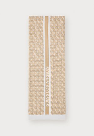 Towel in beige with white geometric pattern. Features a central strip with "GUESS LOS ANGELES" in bold white text and white hem at the bottom.