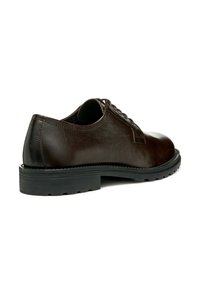 Zapato oxford de cuero marrón con punta redonda, textura suave, suela de goma negra y detalles de cordones. Diseño minimalista con una construcción robusta.