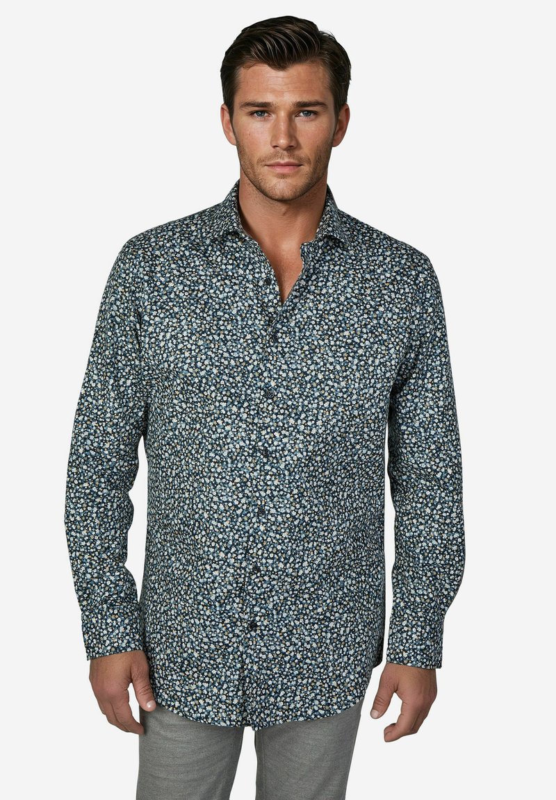 Overhemd met knopen in donkerblauw met een wit en lichtblauw bloemenpatroon, lange mouwen en een puntige kraag, gemaakt van lichtgewicht stof.
