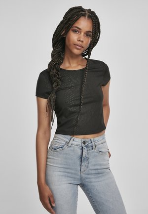 Black cropped t-shirt with short sleeves, featuring a textured design. Paired with high-waisted light blue jeans. Simple, casual style.