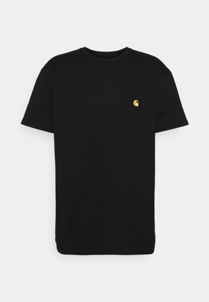 T-shirt en coton noir à manches courtes, col rond, avec un petit logo jaune sur la partie gauche de la poitrine. Design simple et coupe régulière.