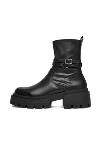 Melna ādas potīšu zābaku ar masīvu griezumu, bloku papēdi, noapaļotu purngalu un dekoratīvo siksniņu ar sudraba sprādzi ap potīti.