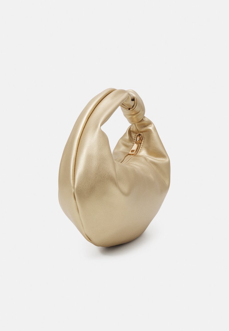 Bolso de mano de cuero dorado con una forma suave y redondeada y un asa anudada. Presenta un cierre de cremallera, mostrando una textura suave.