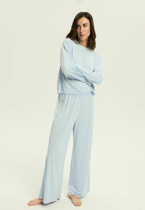 Light blue, long-sleeve top and wide-leg pants set made from soft fabric. Features a relaxed fit and elastic waistband.