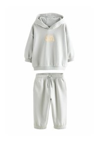 Hellgrauer Hoodie und Jogger-Set aus weichem Material. Der Hoodie hat einen Frontgrafik mit dem Text "Cool Vibes" in hellem Beige. Elastische Bündchen.