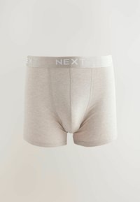 Bež pamukaste bokserice s mekom teksturom, s bijelim "NEXT" logom na pojasu, i prilagođenim dizajnom bez uzoraka.