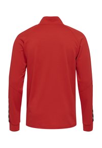 Rotes Langarmoberteil mit strukturiertem Finish, ausgestattet mit einem Reißverschlusskragen und kontrastierenden schwarzen Seitenstreifen. Entworfen für eine figurbetonte Silhouette.
