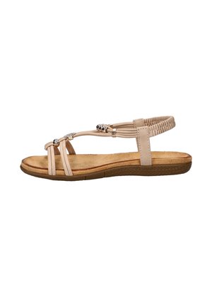 Beige flat sandal with elastic back strap, multiple narrow front straps, decorative silver beads, and textured brown sole.