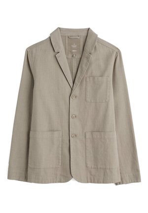 Blazer de algodón beige para hombre con un acabado texturizado, solapas de muesca, cierre de tres botones y dos bolsillos frontales.