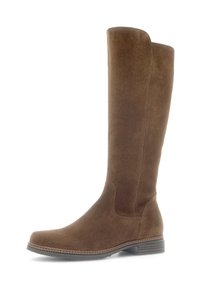 Bottes en suède marron jusqu'aux genoux avec une texture lisse, un bout arrondi et un fin bord cousu le long de la semelle. Semelle extérieure en caoutchouc plat.