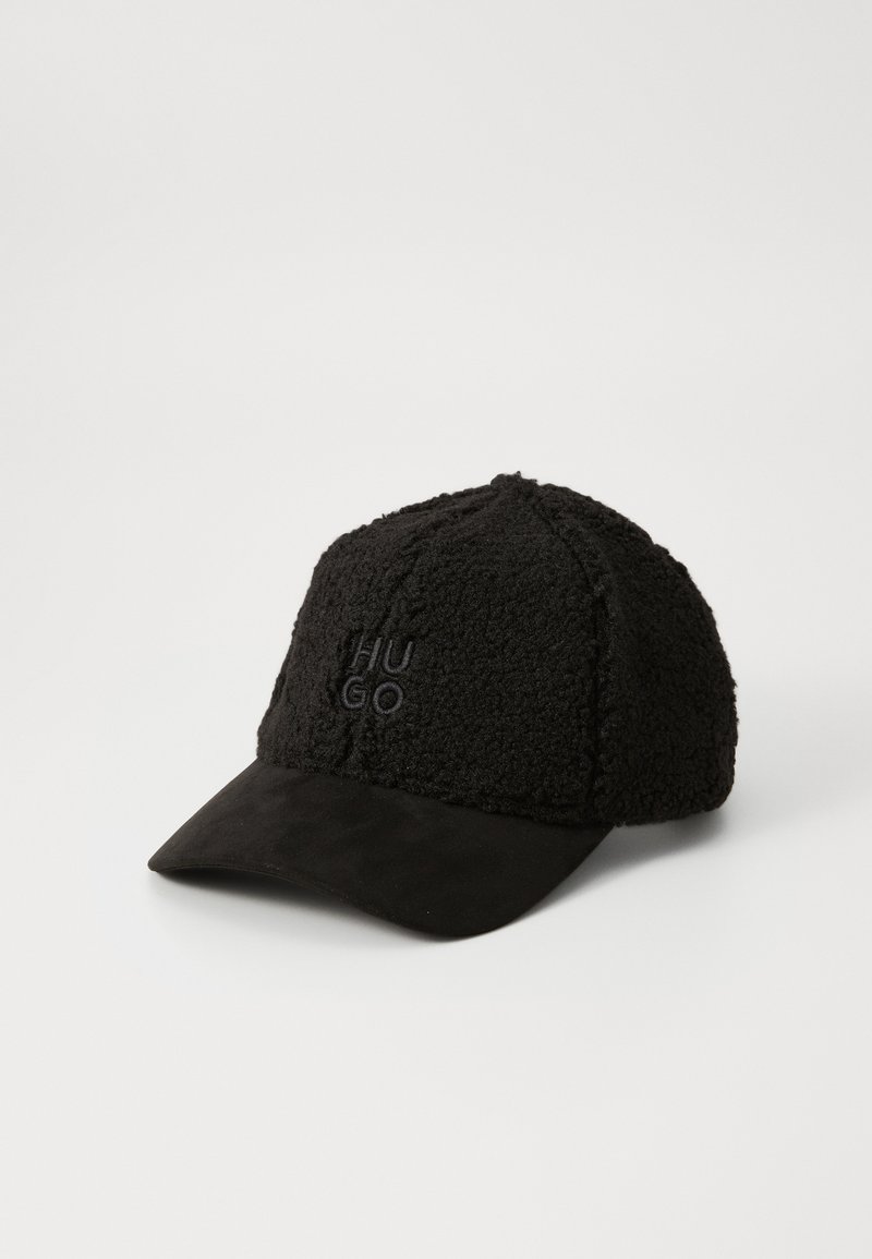 Black cap with a textured, fuzzy fabric body and a smooth black visor. Features embroidered "HUGO" logo on the front.