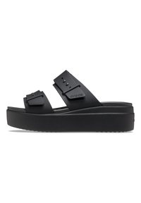 Black platform sandals with dual adjustable straps, made of soft material. Features decorative hardware and textured sole.