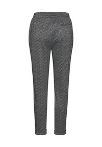 Schwarze und weiße Hahnentrittmuster-Hosen mit einem elastischen Bund, schmal zulaufenden Beinen und seitlichen Taschen. Weicher, strukturierter Stoff.