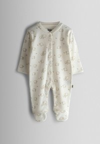 Valge beebikombekas helepruuni lambaprindiga, esiküljel trukkidega, pikkade varrukatega ja jalatükkidega. Pehme puuvillane materjal.