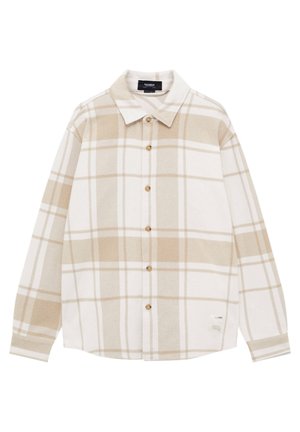 Chemise à manches longues à carreaux beige et blanc, avec col et petite étiquette de marque près de l'ourlet.