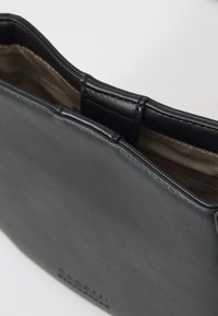 Borsa a tracolla in pelle nera con una texture liscia e una forma ben definita. L'interno presenta una fodera stampata, cuciture visibili e una chiusura a patta superiore.