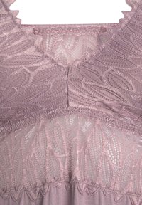 Lace top in soft mauve, featuring scalloped edges and intricate floral patterns, with a smooth fabric beneath the lace detailing.