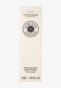 Verpakking van L'Occitane handbalsem in rechthoekige vorm, crèmekleurig met een zwart cirkellogo waarop staat "25% sheaboter," 150 ml. Tekst op de achterkant.