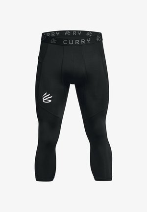 Leggings de compression en tissu noir, présentant un logo CURRY sur la taille et sur le côté. Texture lisse avec un design ajusté et longueur cheville.
