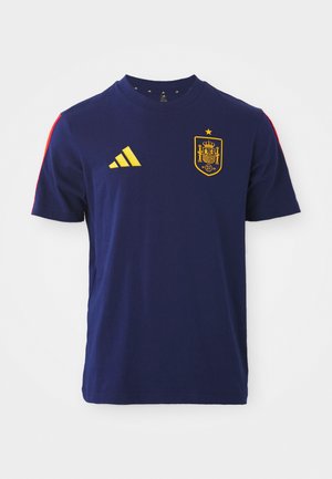 Ναυτικό μπλε βαμβακερό T-shirt με κίτρινο λογότυπο Adidas και έμβλημα της εθνικής ομάδας της Ισπανίας με κόκκινες λεπτομέρειες στους ώμους. Κλασικός σχεδιασμός με στραγγιστό λαιμό.