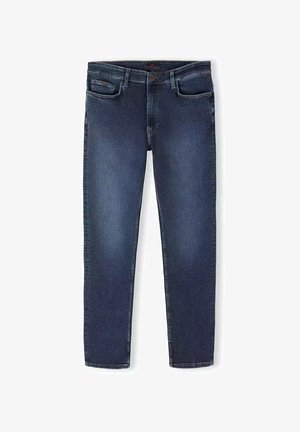 Granatowe dżinsy wąskie, w stylu slim fit, z kieszeniami z przodu, z zapięciem na zamek błyskawiczny oraz minimalistycznym przeszyciem. Tkanina ma gładką fakturę.