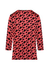 Long-sleeve top in coral fabric featuring a black abstract pattern. Rounded neckline and relaxed fit with a slightly textured surface.