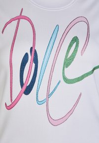 White fabric T-shirt featuring multicolored rhinestone embellishments spelling "DOLCE" in blue, green, pink, and dark blue with curved lines.