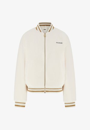 Bomberjacke in Cremefarbe mit weichem, strukturiertem Stoff. Verfügt über einen goldenen Reißverschluss, gestrickte Bündchen sowie einen gestreiften Kragen und Saum. "GUESS"-Logo auf der Vorderseite.