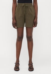 Olive green linen blend shorts with an elastic waistband and drawstring. Features a relaxed fit, knee-length cut, and subtle texture.