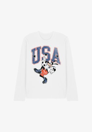 Weißes Langarmhemd mit großem "USA"-Schriftzug und einem Cartoon-Charakter, der Fußball spielt und den Ball mit einem Fuß jongliert.