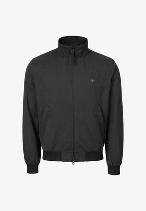 Giacca leggera nera con zip, collo alto, polsini ed orlo elastici, e tasche laterali, con un piccolo logo sul petto.