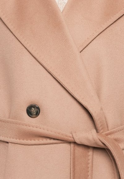 Light pink wrap coat in a soft fabric, featuring a large collar, a double-breasted design, and a fabric tie belt, with a black button detail.
