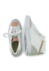 White sneakers with gray and tan suede accents, metallic details, textured sole, and traditional lacing. Smooth leather upper finish.
