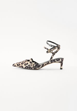 Leopard print high-heeled shoe with pointed toe and narrow ankle straps, featuring a black strap and subtle gold accents.