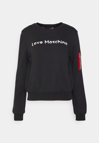 Černá mikina z bavlněné směsi, obsahuje bílé text "Love Moschino", vroubkované manžety a červenou kapsu na zip s detaily srdce.