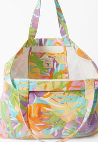 Sac en toile avec un motif de feuilles tropicales vives en orange, vert, violet et bleu. Texture douce, ouverture en haut et deux poignées robustes.