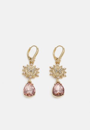 Gold lever-back earrings with ornate butterfly and pearl accents, featuring large teardrop-shaped pink gemstones hanging below.