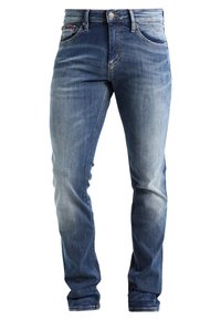 Pánské úzké modré džíny z denimu s bledým ombré, předním zapínáním na knoflík a zip, a předními i zadními kapsami.