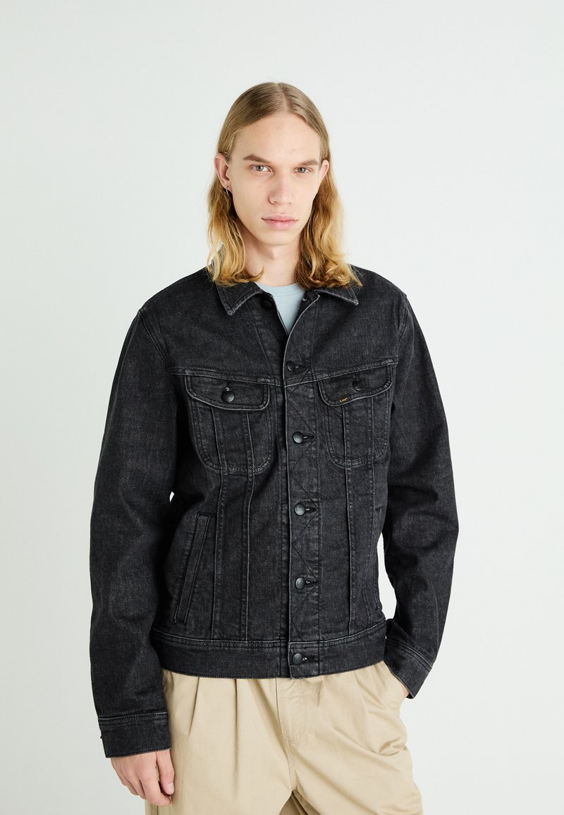 Black denim jacket with two chest pockets, button closure, and a structured design. Features stitched detailing and a casual fit.